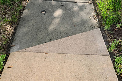 residential sidewalk cleaned using hot pressure washing